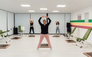 a group of people doing exercises in a room