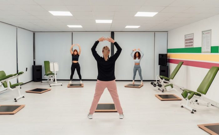 a group of people doing exercises in a room