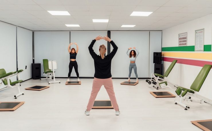 a group of people doing exercises in a room